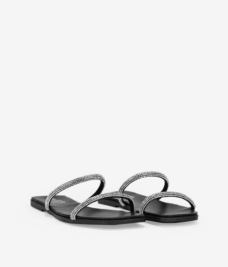 Black flat sandals with two shiny silver straps
