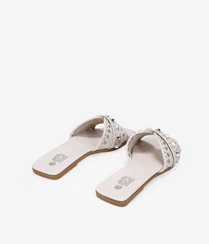Beige flat sandals with metal studs