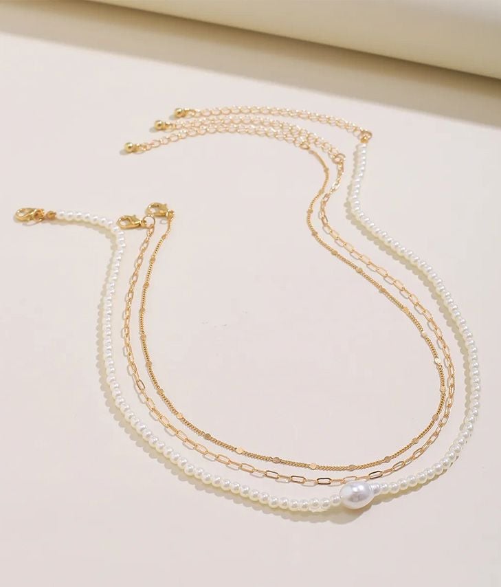 Pack of gold and pearl necklaces