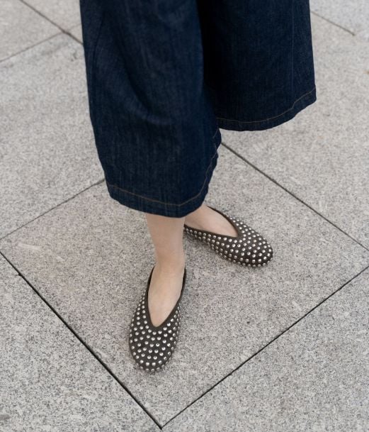 Flat green clogs with studs